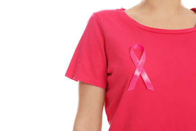 Woman with pink ribbon on white background, closeup. Breast cancer awareness