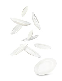 Image of Set of clean dishes in flight on white background