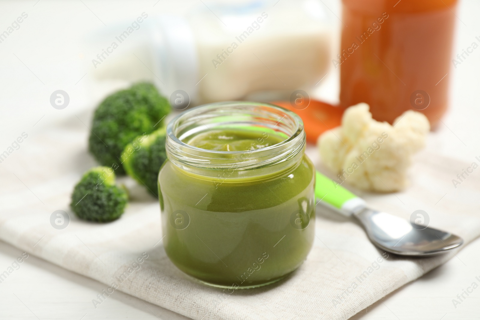 Photo of Healthy baby food and fresh ingredients on white table