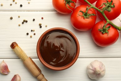 Photo of Flat lay composition with tasty barbeque sauce in bowl on white wooden table