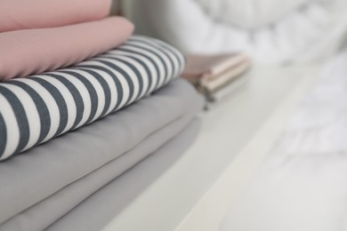Photo of Different colorful bed linens on display in shop, closeup. Space for text