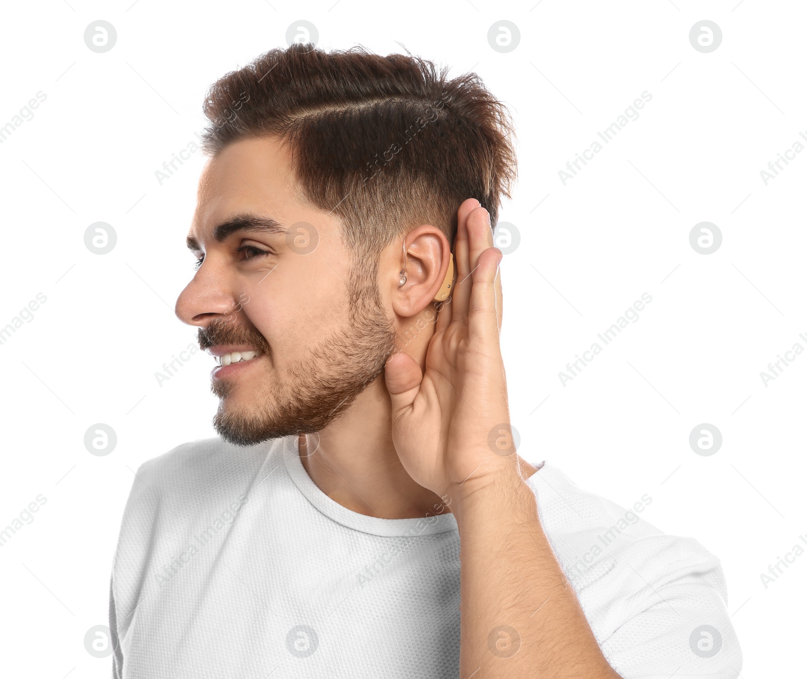 Photo of Young man with hearing aid on white background