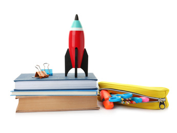 Photo of Bright toy rocket and school supplies on white background