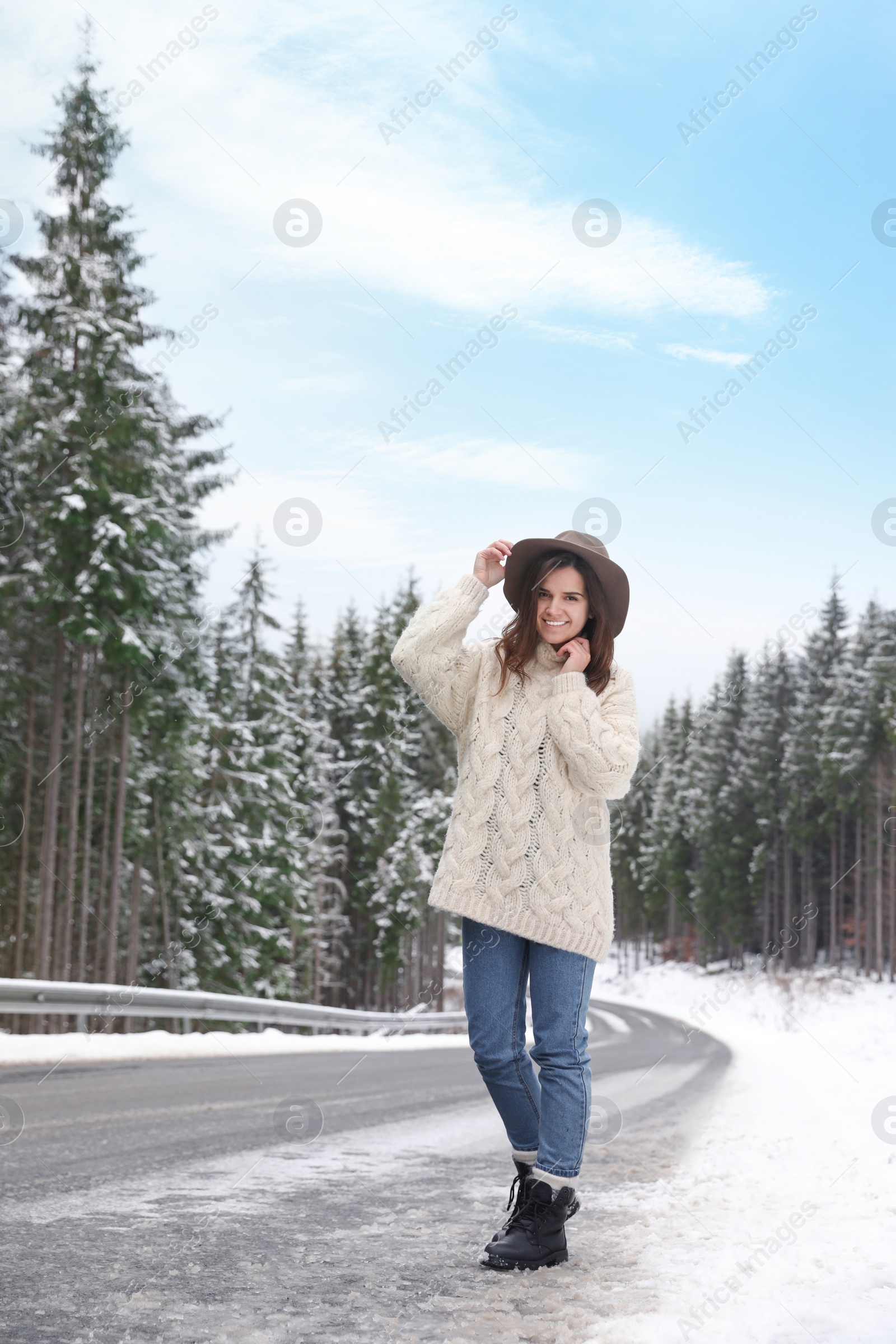 Photo of Young woman walking near snowy forest. Winter vacation