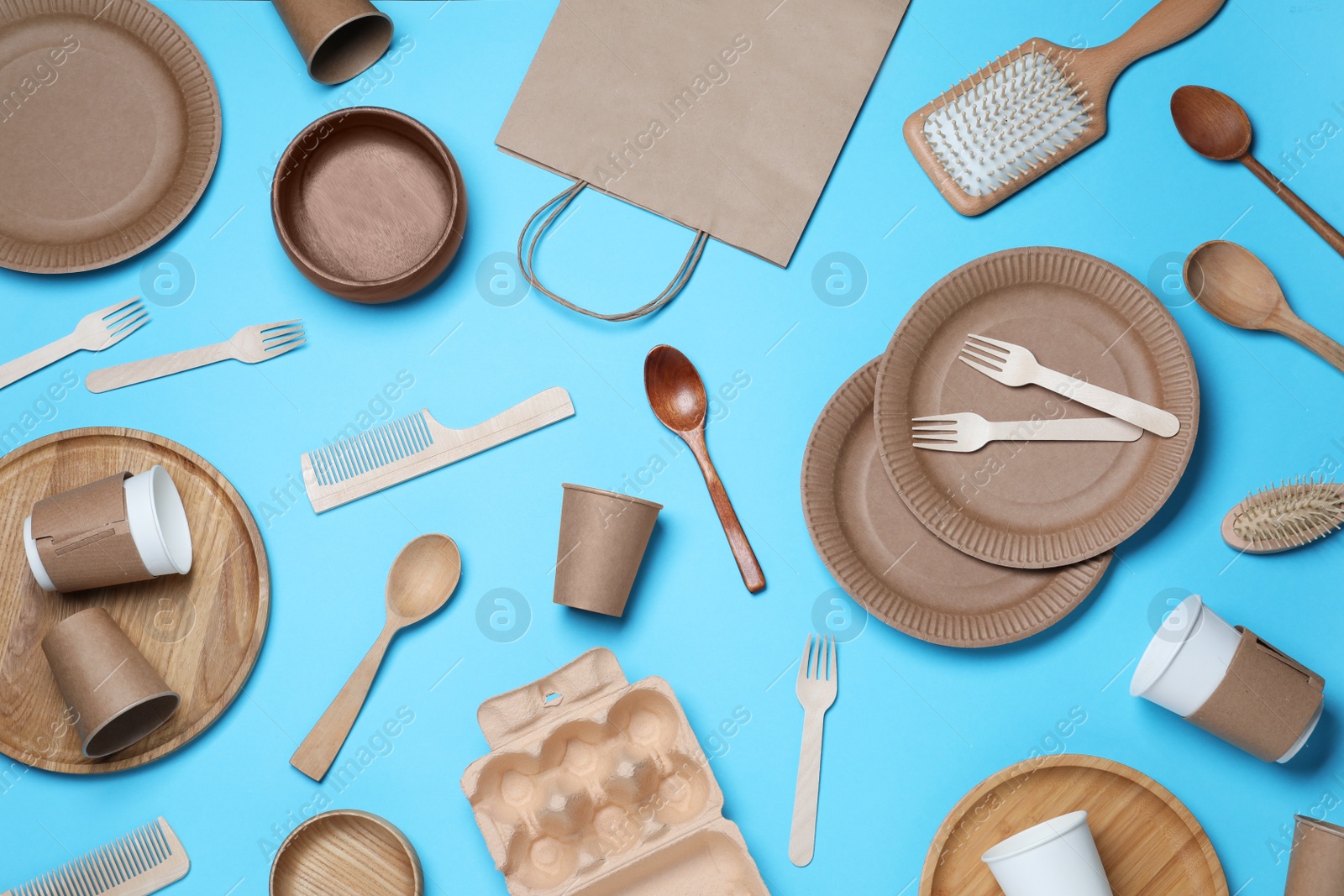 Photo of Different eco items on light blue background, flat lay. Recycling concept