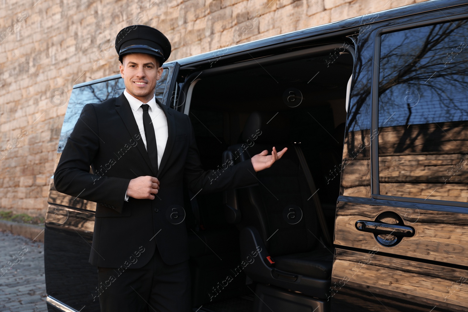 Photo of Professional driver near luxury car. Chauffeur service