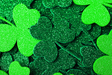 Photo of Green clover leaves as background, top view. St. Patrick's Day celebration