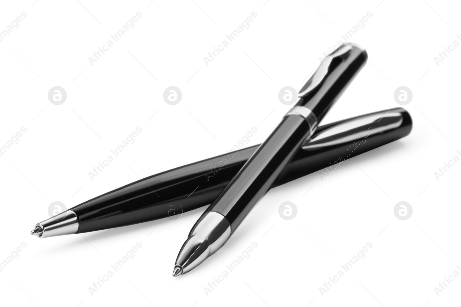 Photo of New stylish black pens isolated on white, closeup