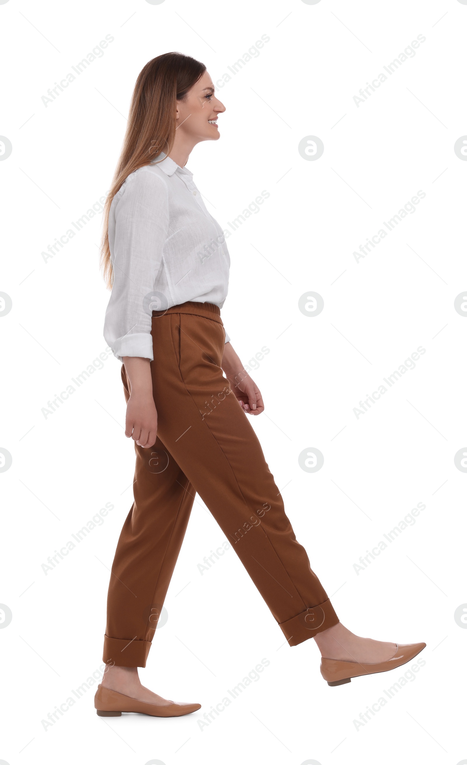 Photo of Beautiful happy businesswoman walking on white background