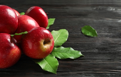 Fresh ripe red apples on wooden background