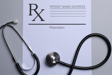 Photo of Medical prescription form and stethoscope on light grey background, flat lay
