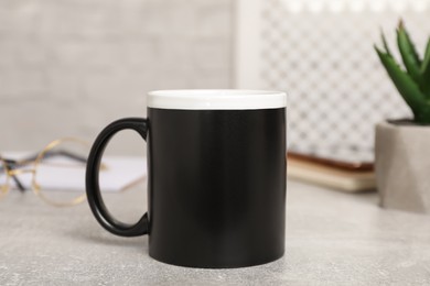 Photo of Mug of hot drink on light grey table in office. Coffee Break