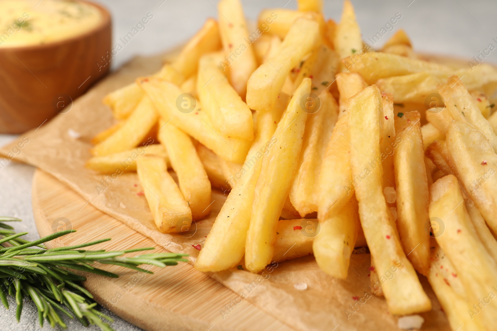 Photo of Delicious french fries with rosemary on table, closeup