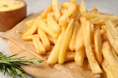 Delicious french fries with rosemary on table, closeup