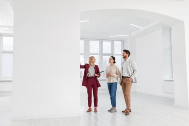 Real estate agent showing new apartment to couple