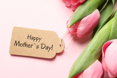 Happy Mother's Day greeting label and beautiful tulip flowers on pink background