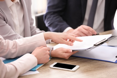 Young consultant working with clients in office