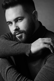 Portrait of handsome bearded man on dark background. Black and white effect