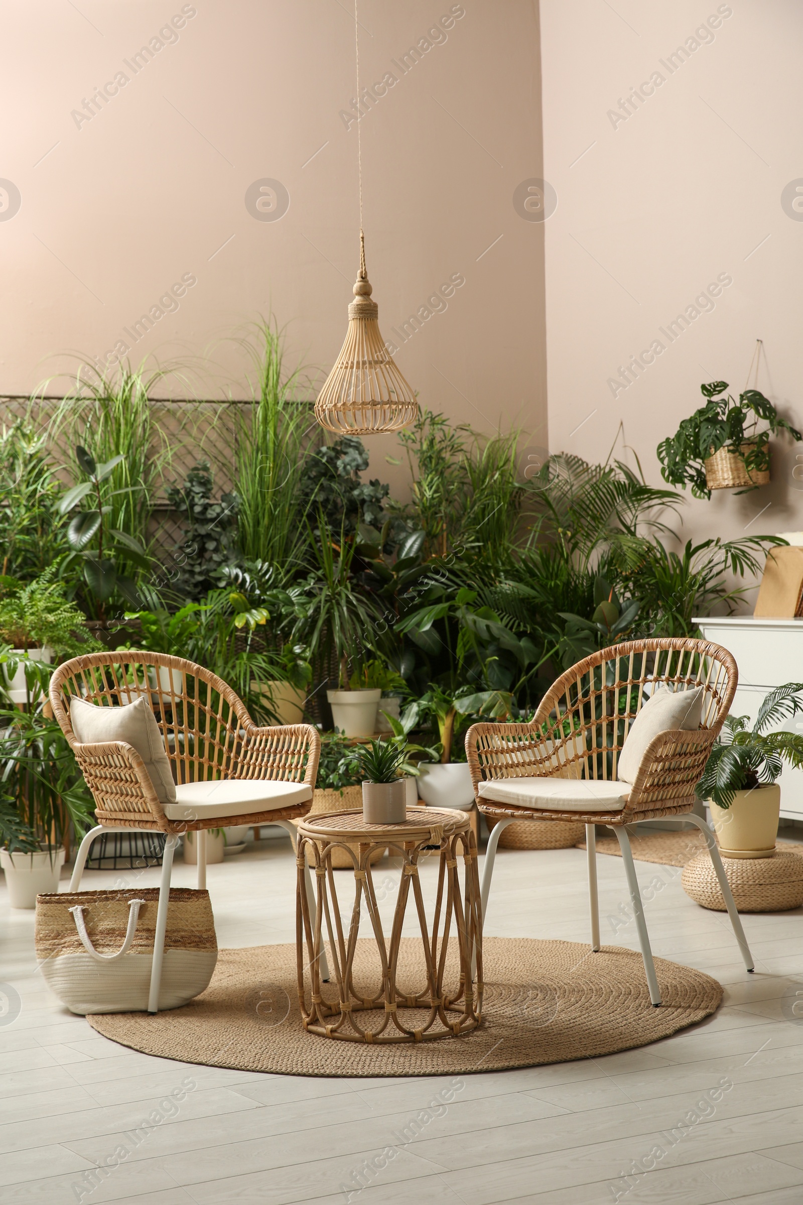 Photo of Room interior with stylish furniture and different houseplants