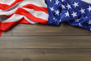 Photo of American flag on wooden table, top view with space for text. Memorial Day