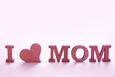 Phrase "I LOVE MOM" made of letters on color background. Happy Mother's Day