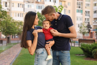 Happy family with adorable little baby outdoors