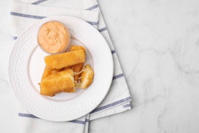 Photo of Plate with tasty fried mozzarella sticks and sauce on white marble table, top view. Space for text