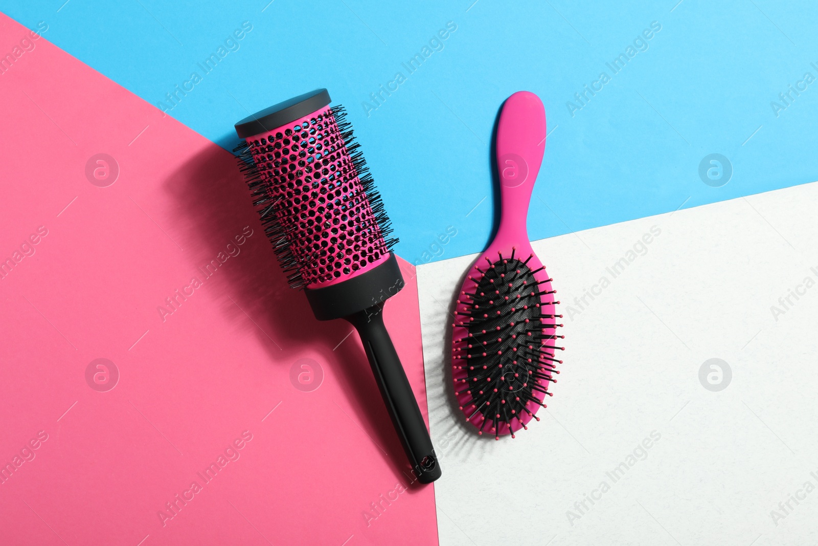 Photo of New hair brushes on color background, flat lay