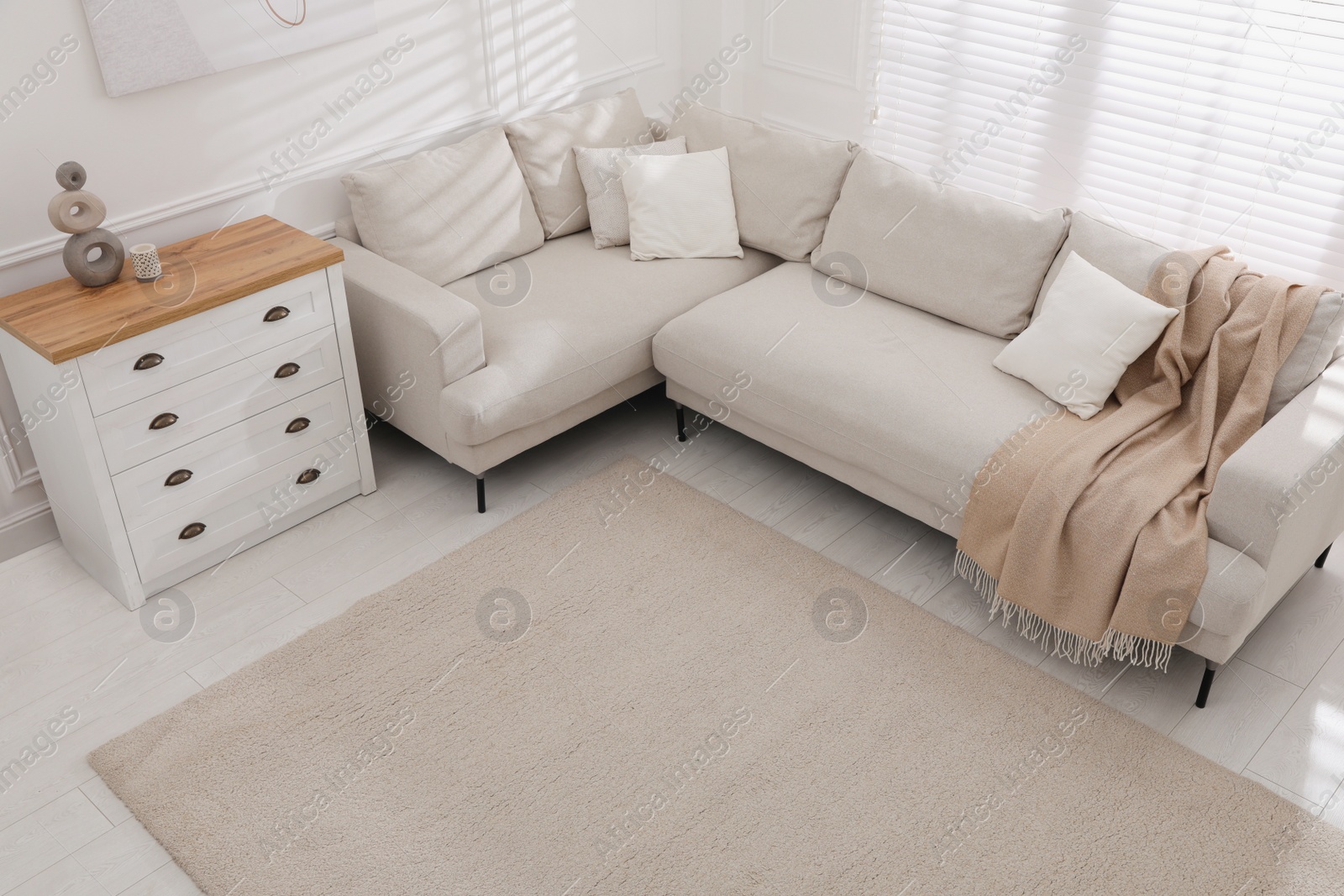 Photo of Stylish soft carpet on floor in living room, above view
