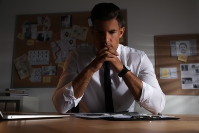 Detective working at desk in his office