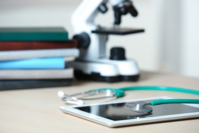 Stethoscope and tablet on table, closeup. Medical students stuff