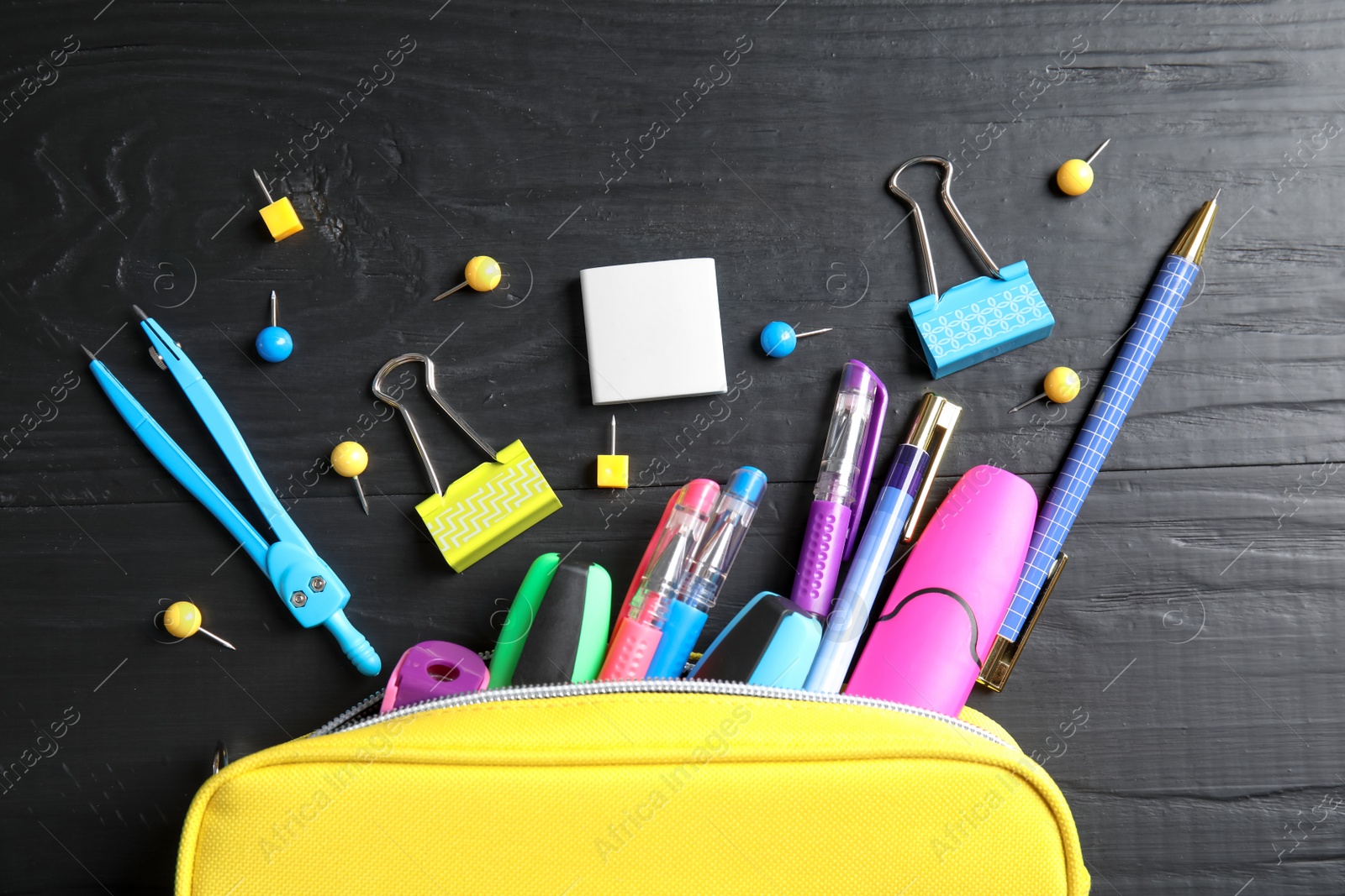 Photo of Different school stationery on wooden background, flat lay