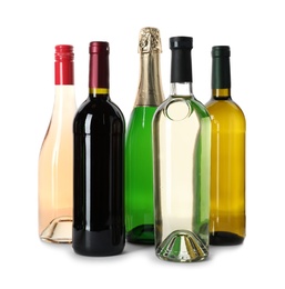 Bottles with different alcoholic drinks on white background