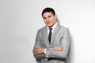 Photo of Portrait of young businessman on light background