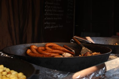 Delicious cooked sausages in frying pan indoors