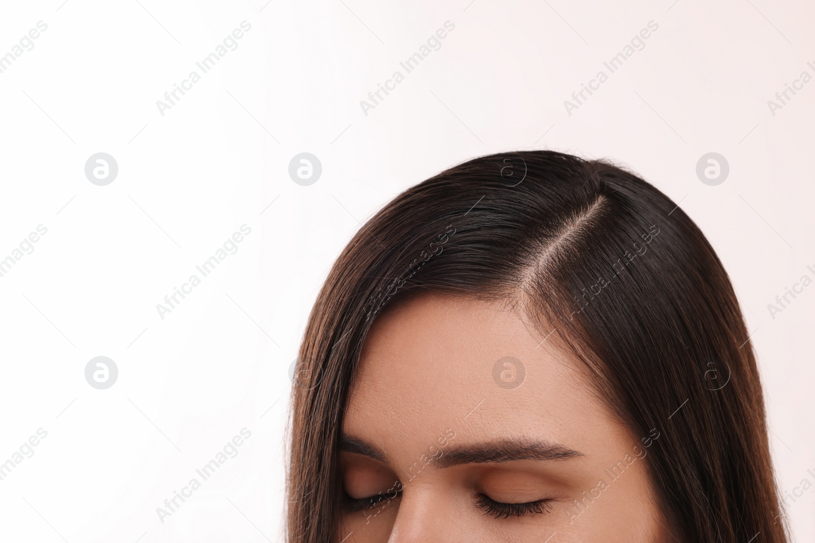Photo of Woman with healthy hair on white background, closeup. Space for text