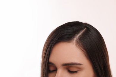 Woman with healthy hair on white background, closeup. Space for text