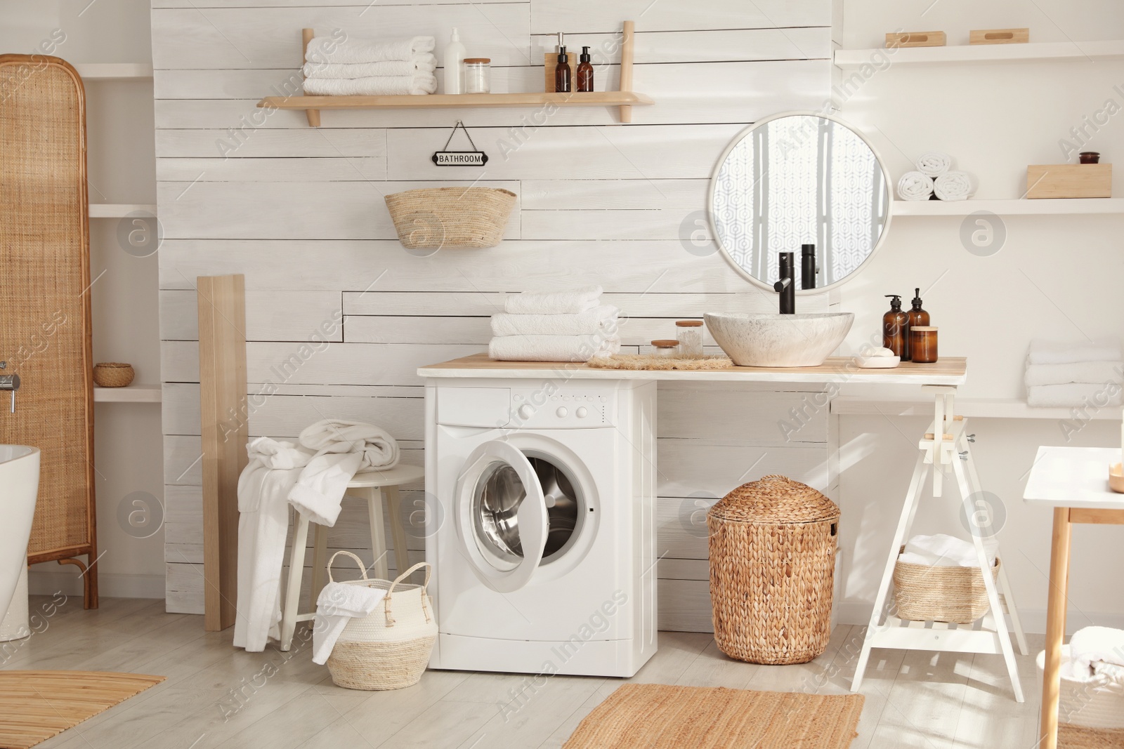 Photo of Stylish bathroom interior with modern washing machine