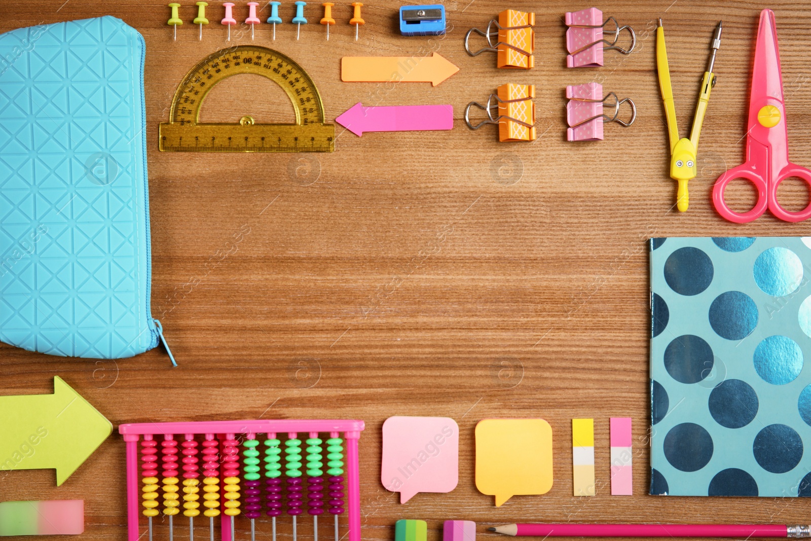 Photo of Different school stationery with space for design on wooden background, flat lay