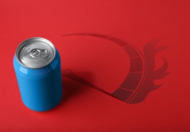 Image of Energy drink and shadow in shape of speedometer with fire on red background 