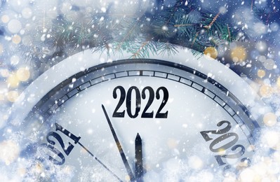 Image of Clock counting last moments to New 2022 Year and beautiful fir branches. Bokeh effect