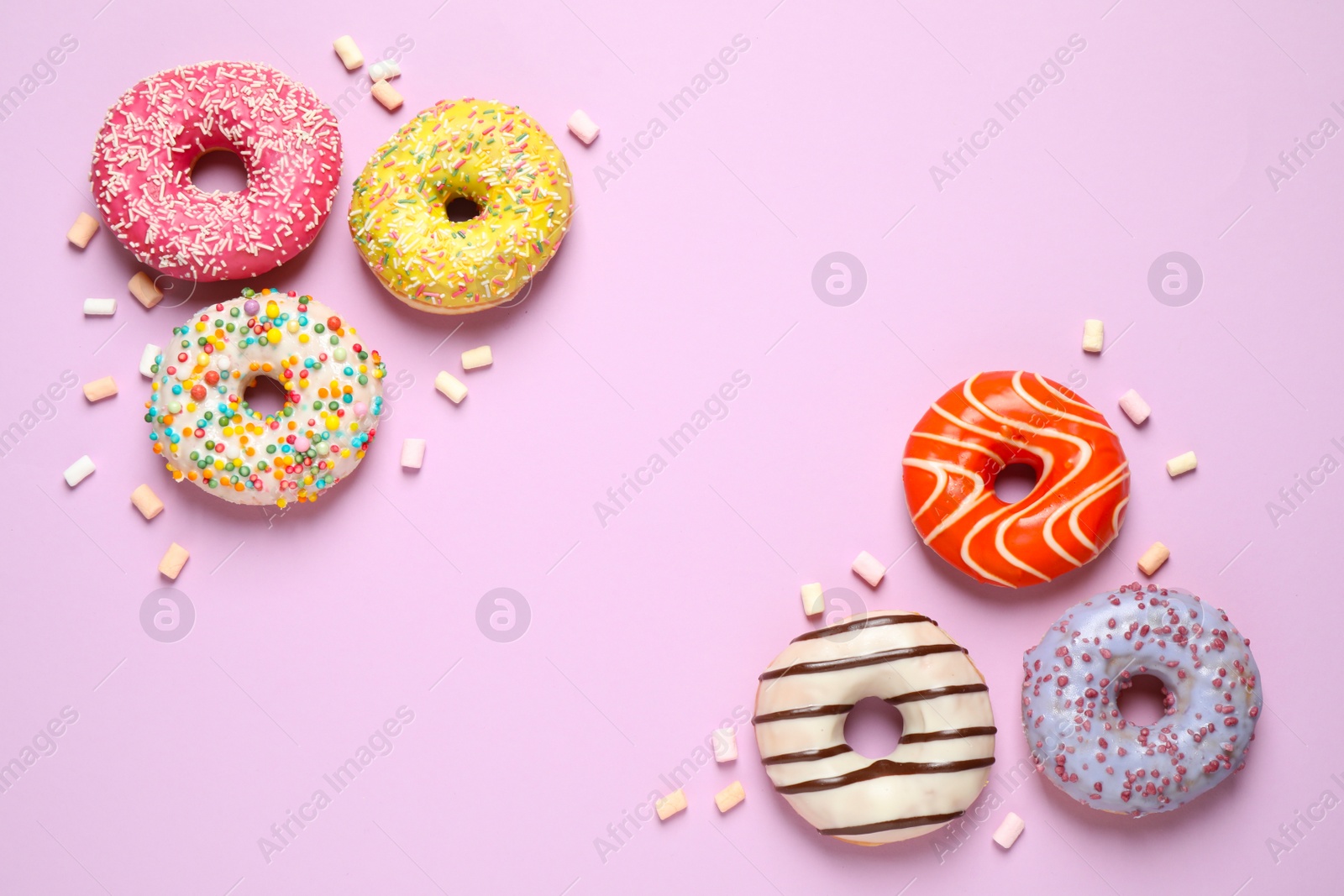 Photo of Delicious glazed donuts on lilac background, flat lay. Space for text