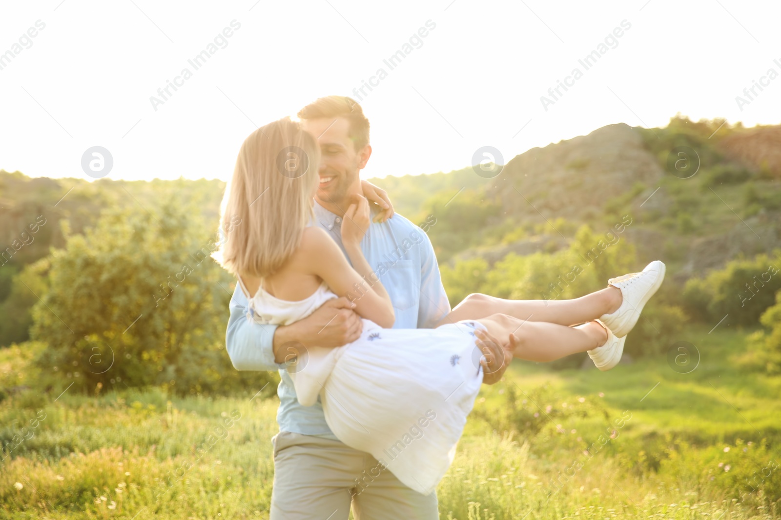 Photo of Cute young couple in love posing outdoors on sunny day