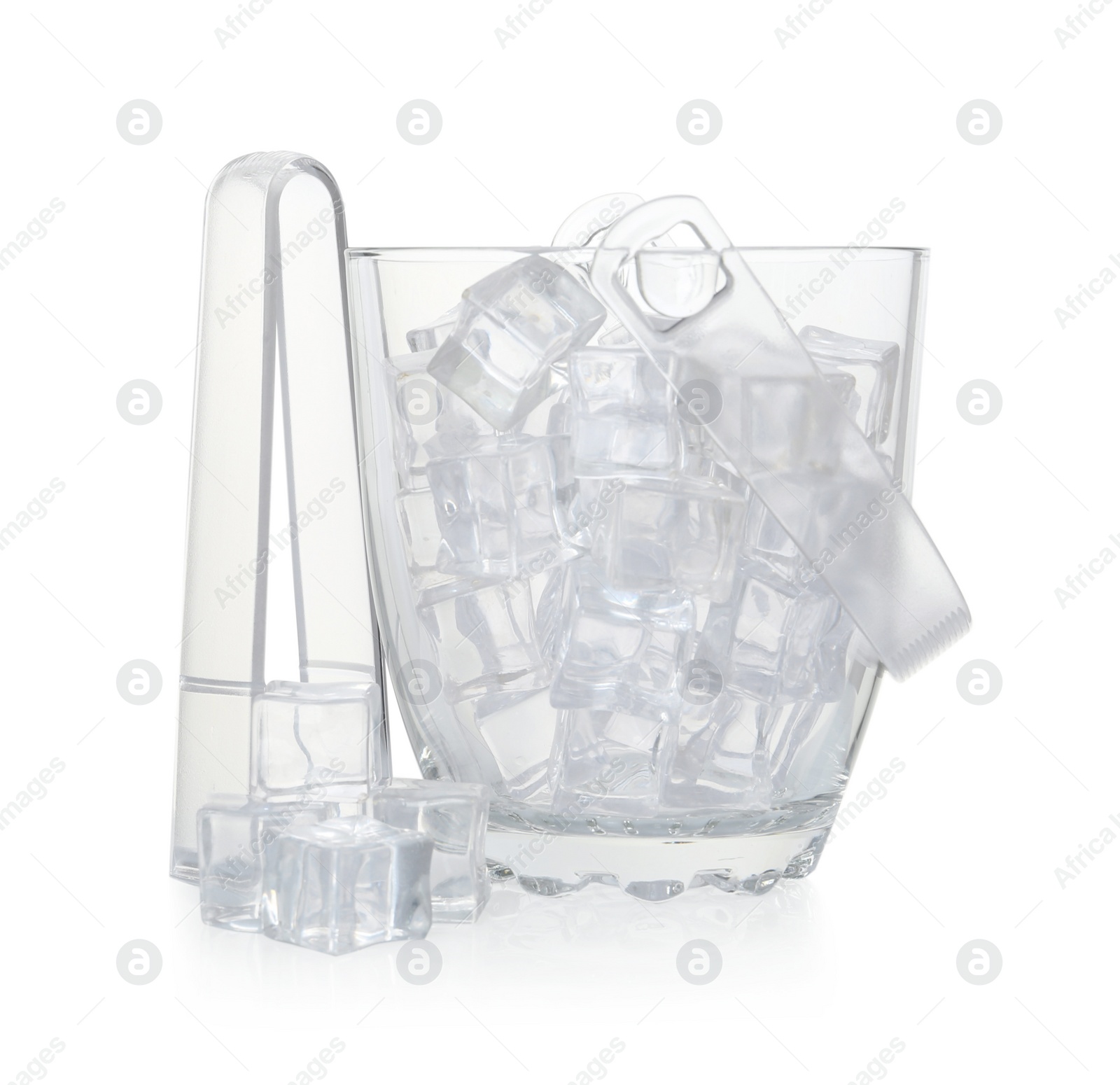 Photo of Glass bucket with ice cubes and tongs on white background