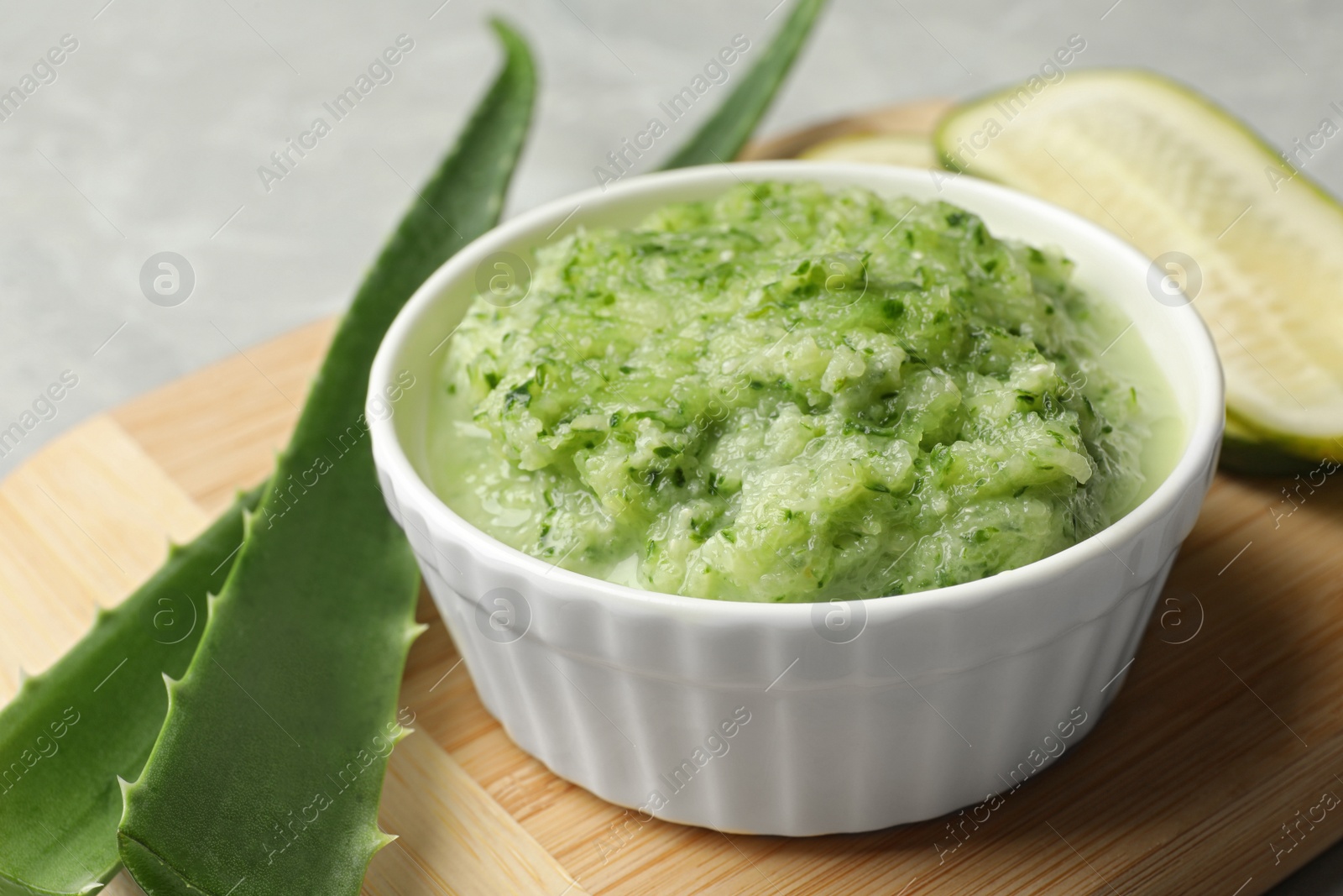 Photo of Handmade face mask and fresh ingredients on grey table, closeup