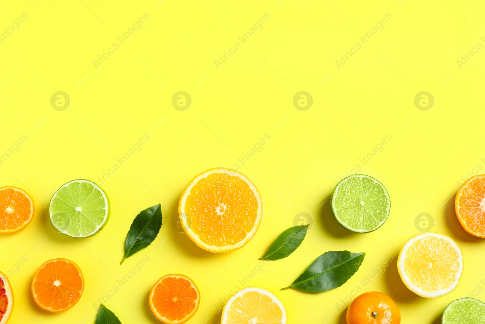 Photo of Different citrus fruits and leaves on color background, flat lay. Space for text