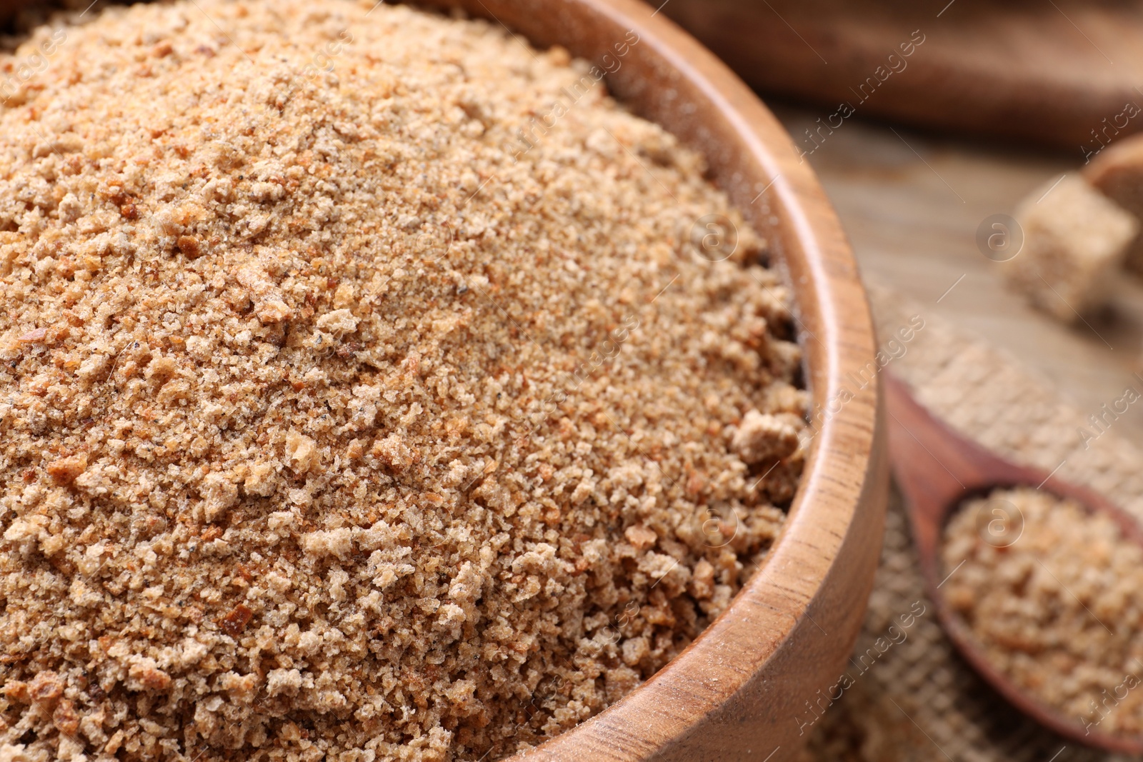 Photo of Fresh breadcrumbs in bowl on table, closeup