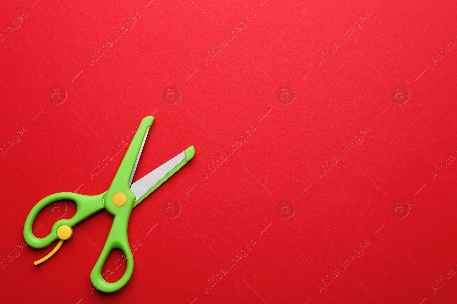 Photo of Training scissors on color background, top view. Space for text