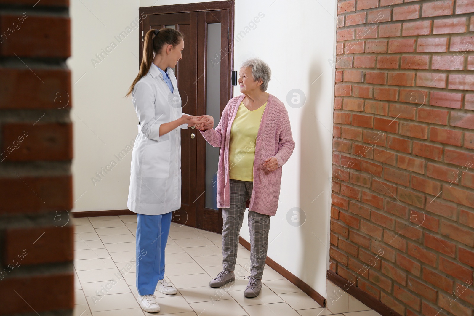 Photo of Doctor helping senior patient at modern clinic