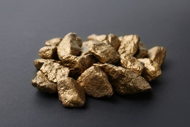 Photo of Pile of gold lumps on dark background